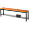 Wooden bench with black metal legs. Below is a shelf for shoes, on which two sports shoes stand.