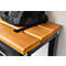 Detail of a wooden bench with a black backpack on top. The bench has a brown wooden top and a black metal frame.