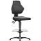 Black office chair, ergonomically shaped with backrest, seat and foot ring.