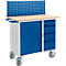 Blue workshop trolley with pegboard, wooden top and drawers. The trolley stands on wheels.