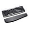 Black keyboard with palm rest. The keyboard is designed for an ergonomic workplace.