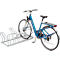 Blue bicycle in a bike rack. Rear wheel with luggage carrier. Silver stand, wheels, spokes.