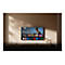 An der Wand hängender Fernseher mit Google TV Benutzeroberfläche und Filmauswahl in einem modern eingerichteten Raum.