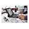 Ein Mann, der an einem Tisch mit einem Tablet-PC und Tastatur arbeitet, mit Bauplänen, einer Kaffeetasse und einer Brille.
