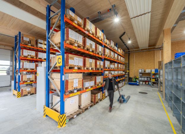 A large warehouse featuring shelves lined with boxes, indicating storage and inventory.