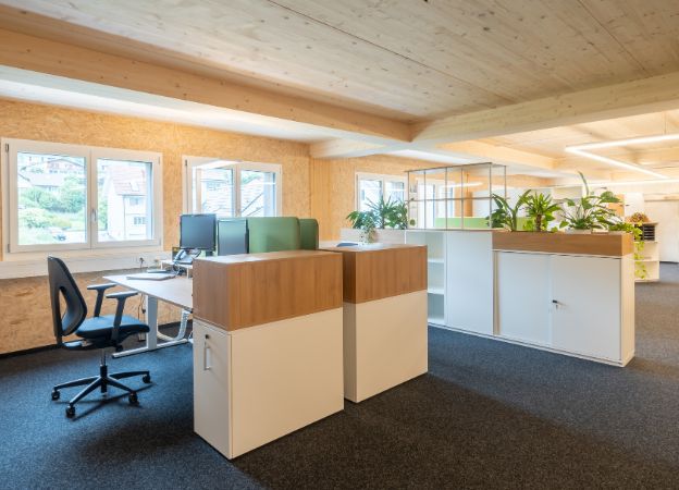 An office featuring wooden walls and a simple desk, creating a warm and inviting workspace atmosphere.