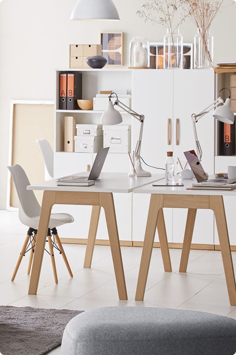 Modern eingerichteter Arbeitsplatz mit Schreibtischen, Stühlen und Stauraum