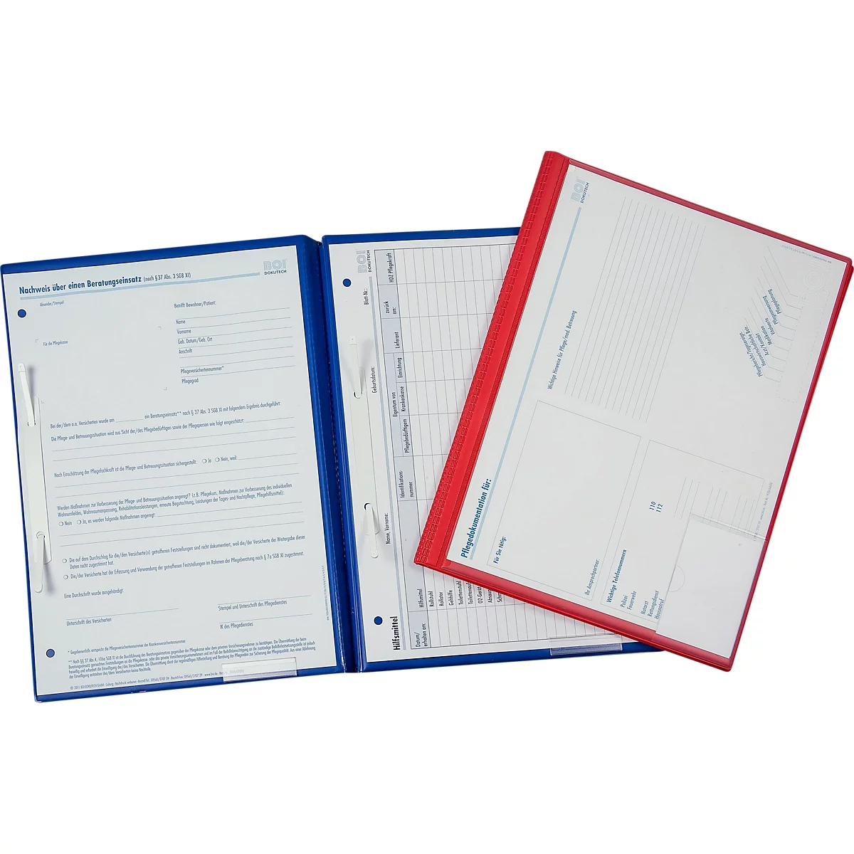 Drei Ordner liegen nebeneinander. Blaue und rote Mappen mit weißen Blättern. Auf einem Blatt steht 'Schrift der neuen Impfgenemigungen'.