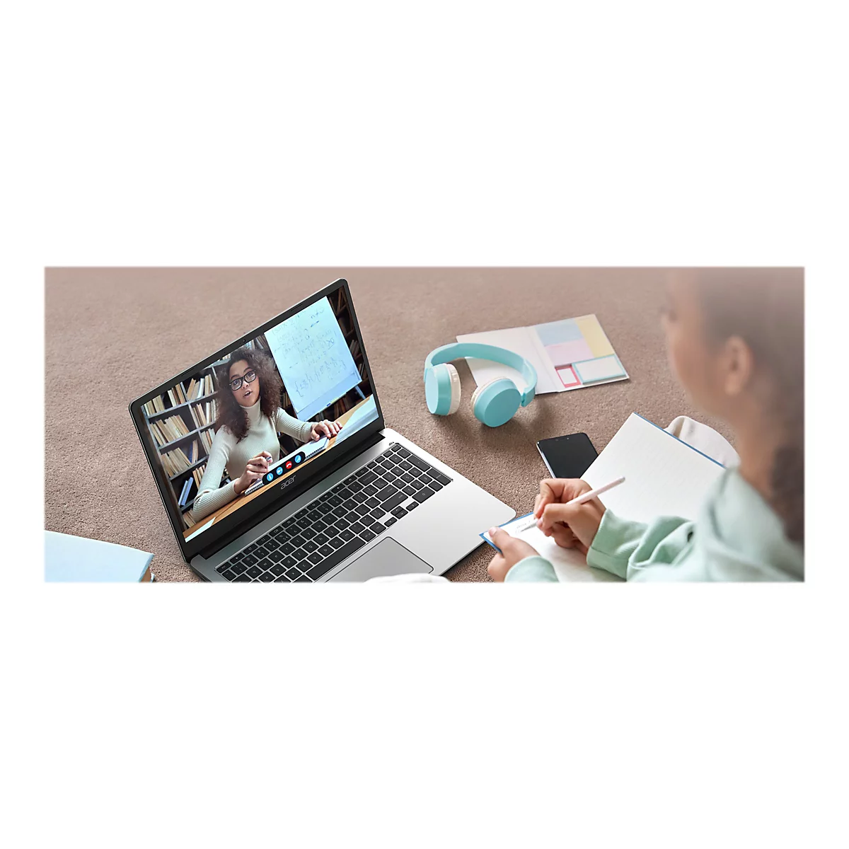 Person schreibt Notizen, wÃ¤hrend sie an einem Online-Kurs teilnimmt, der auf einem Laptop gezeigt wird.