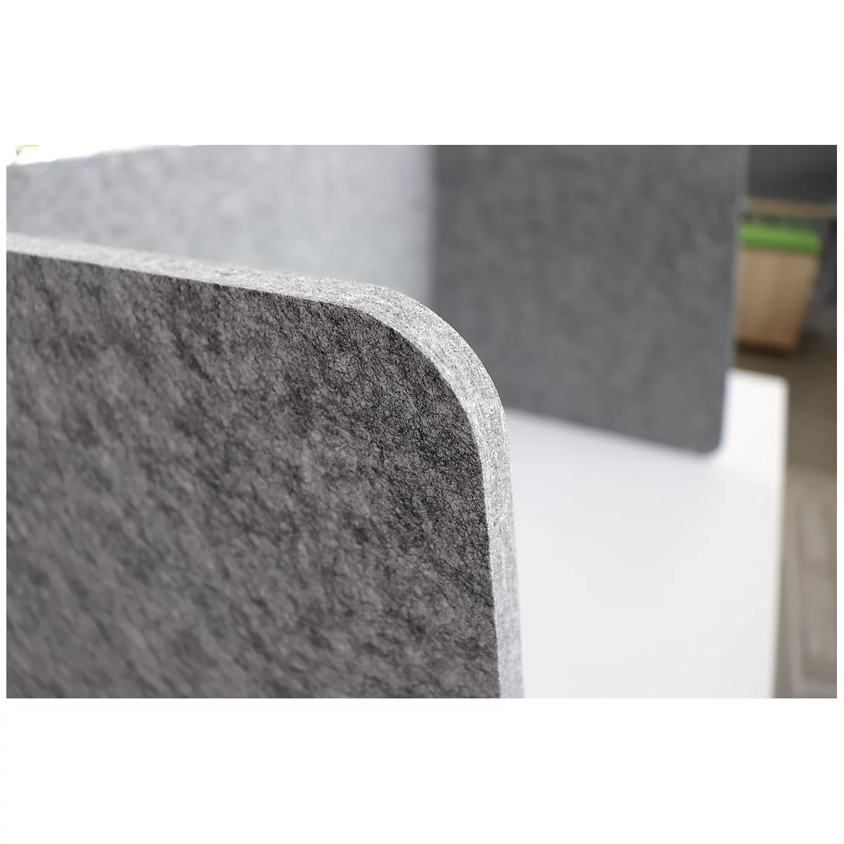 Close-up of a gray, rounded felt board. Other boards in the background.