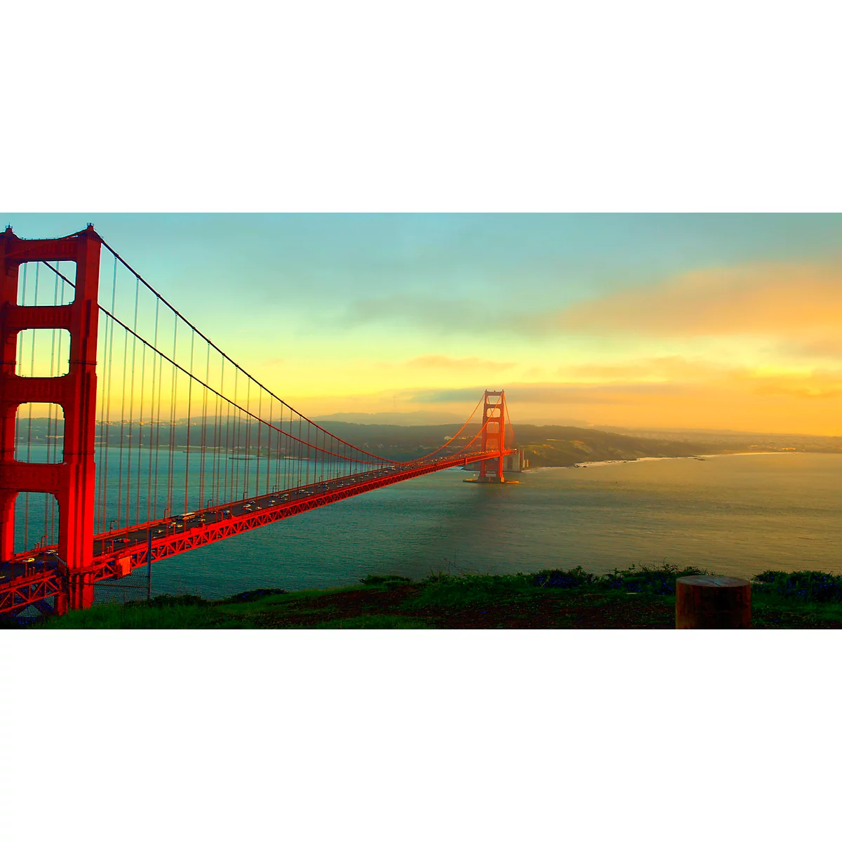 The Golden Gate Bridge in San Francisco, red in sunset mood over water.