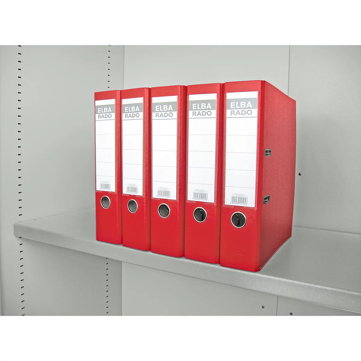 Red folders in a shelf. Text: ELBA RADO.
