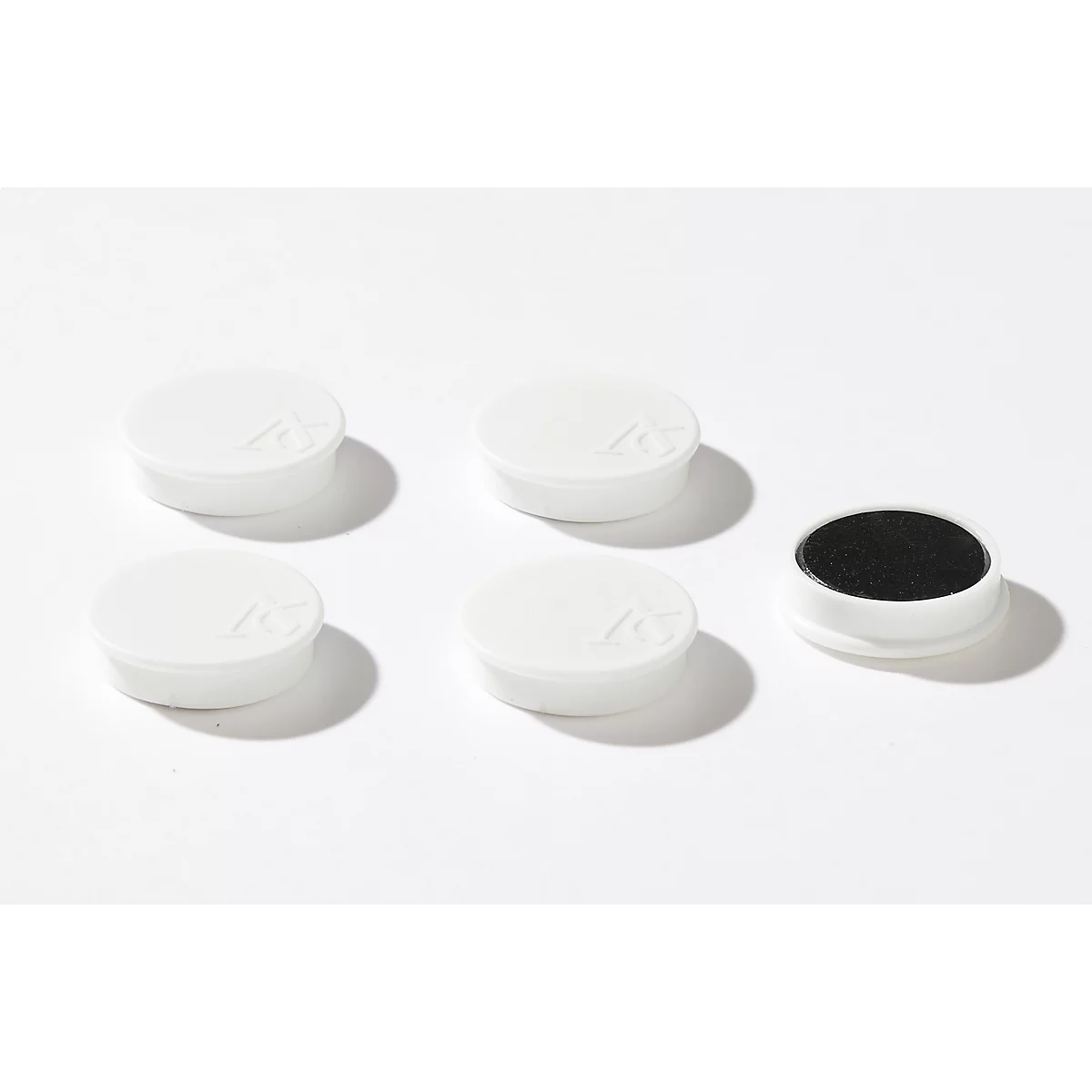 Five white, round containers, one of which is open with black content. All are on a white background.