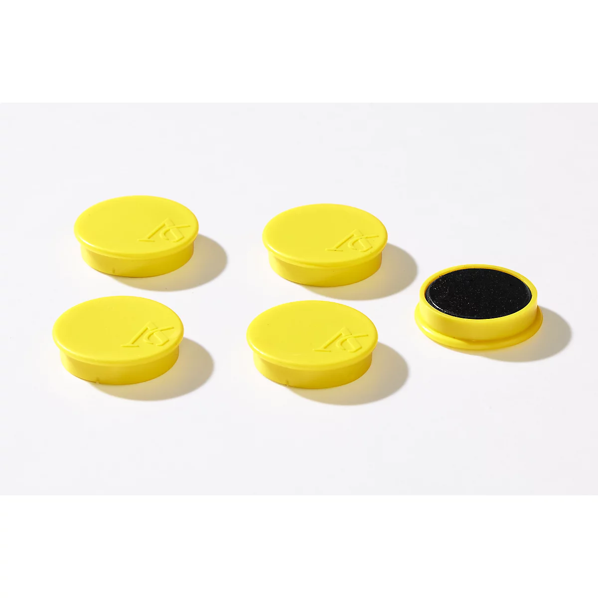 Yellow, round stamp pads and one open pad with black ink on a white background.