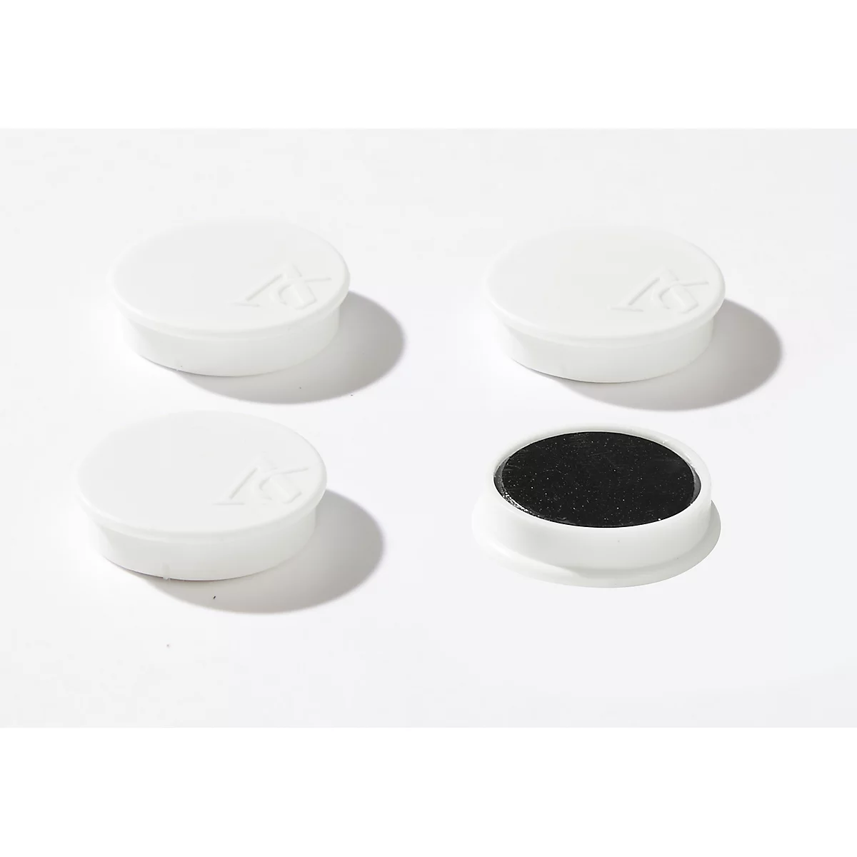Four white, round stamp pads, one of which is open with black ink. A logo is shown on the lids.