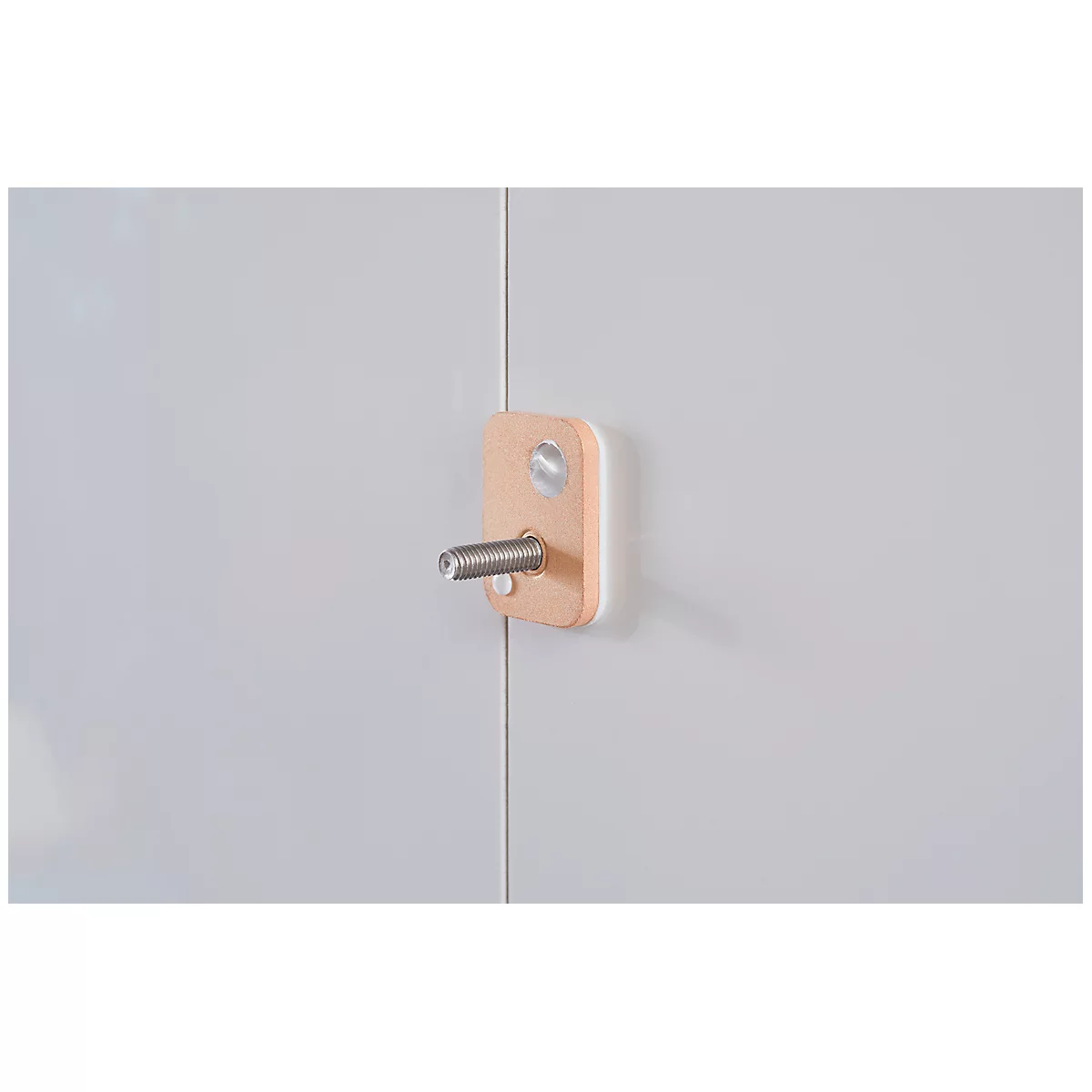 Bright wooden block with screw on white wall. Screw protruding.