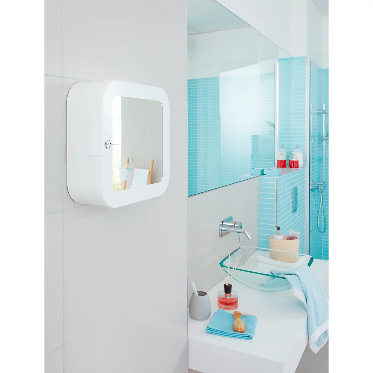 White, square bathroom mirror on the wall. Mirror, sink, towel.