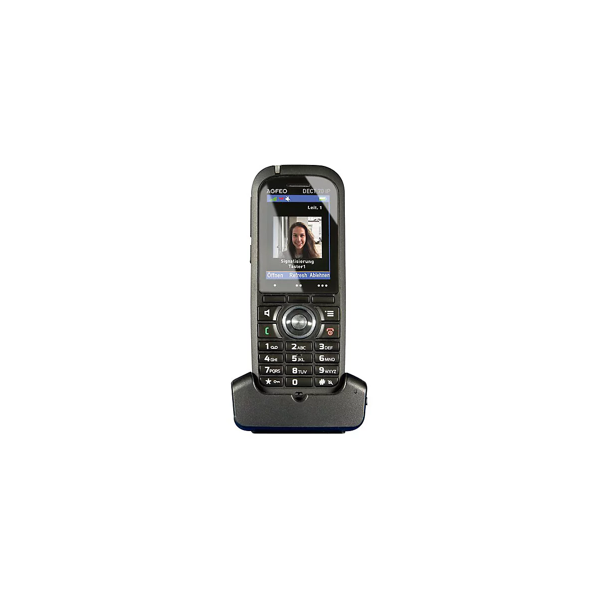 Schwarzes Telefon mit Ladeschale, Display zeigt Videoanruf. Frau lÃ¤chelt. Tastenfeld und Navigationstasten darunter.