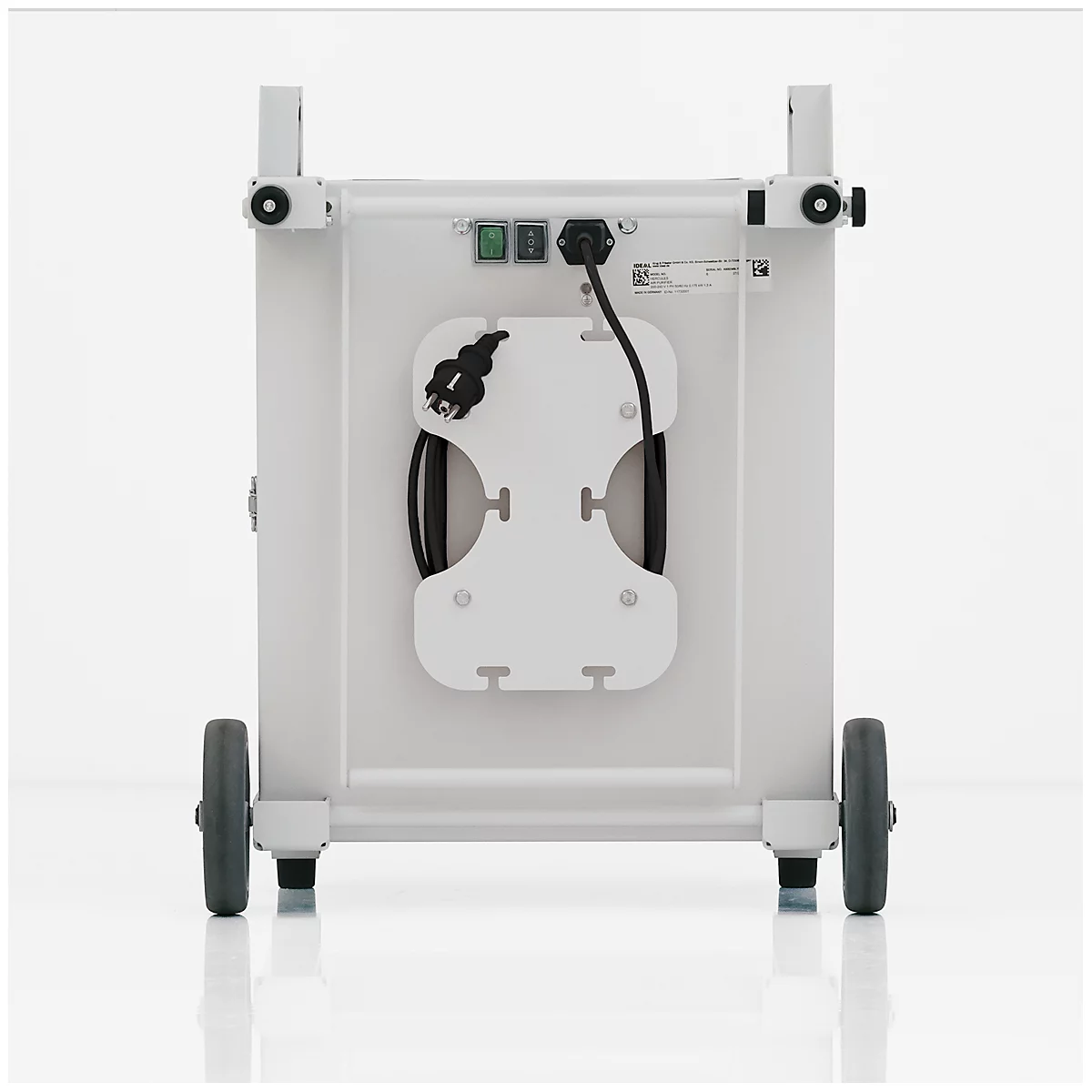 Back of a white medical device. Power cable and plug holder, two wheels at the bottom, two holders at the top.