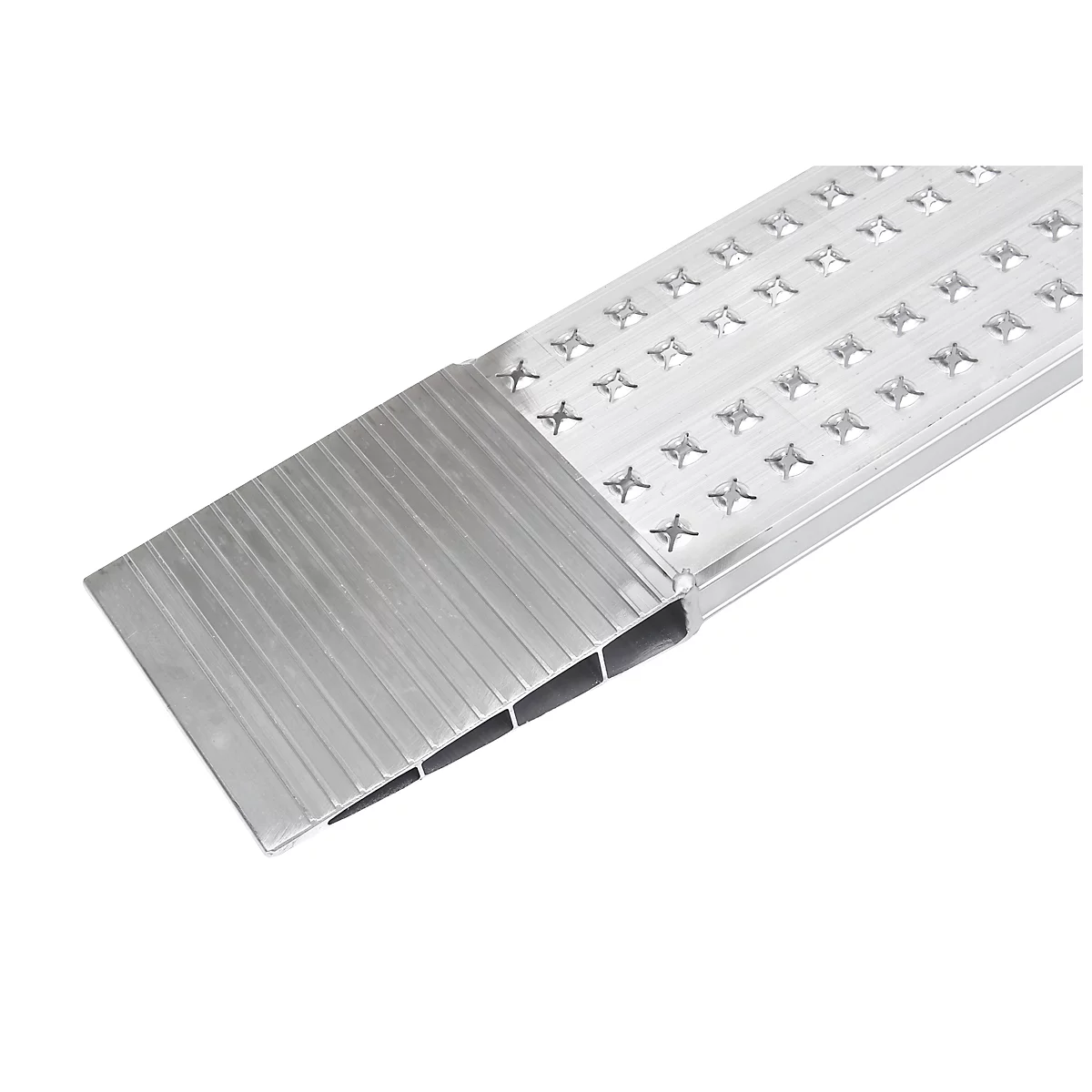 Close-up of a metal ramp with a ridged surface, silver in color and with star-shaped cutouts.