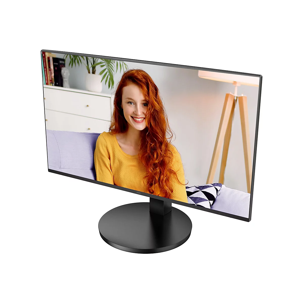 Ein Computerbildschirm zeigt eine Frau mit roten Haaren, die fröhlich lächelt. Der Monitor steht auf einem schwarzen Sockel.