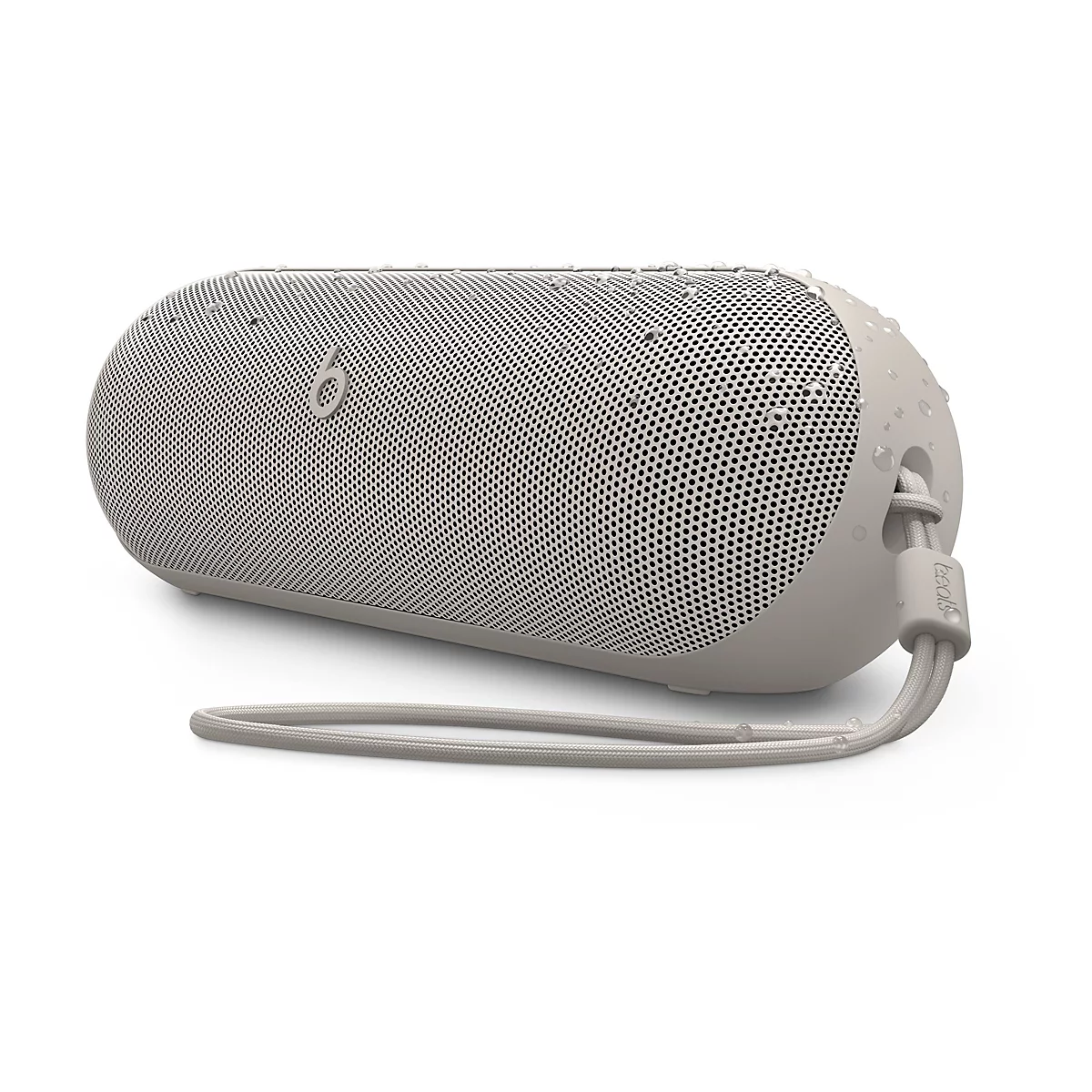 Beige, zylindrischer Bluetooth-Lautsprecher mit Wassertropfen auf der Oberfläche und Trageschlaufe.