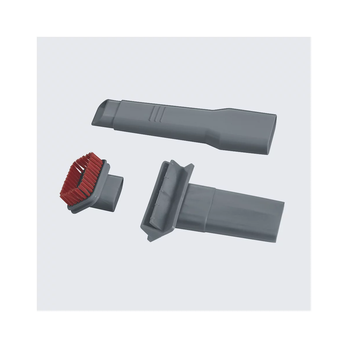 Accessoires d'aspirateur gris ; trois accessoires, un avec une brosse rouge.