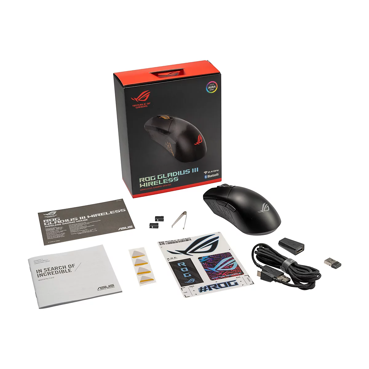 Schwarze ROG Gladius III Wireless Gaming-Maus mit Zubehör auf weißem Hintergrund, einschließlich Box und Kabeln.
