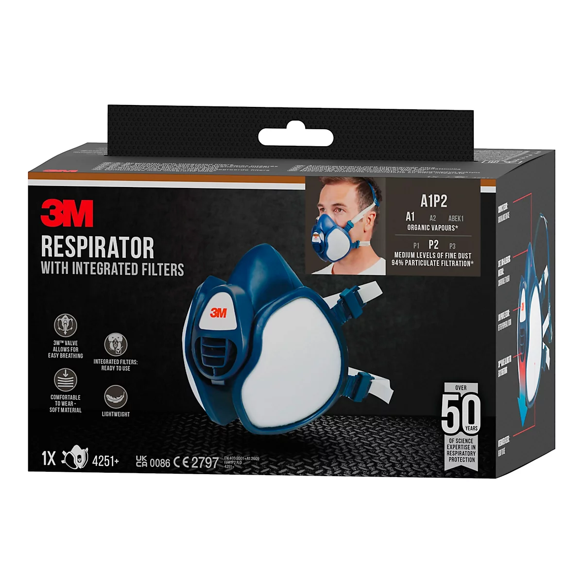 Atemschutzmaske 3M, blau-weiß, mit integrierten Filtern, Produktabbildung auf Verpackung.