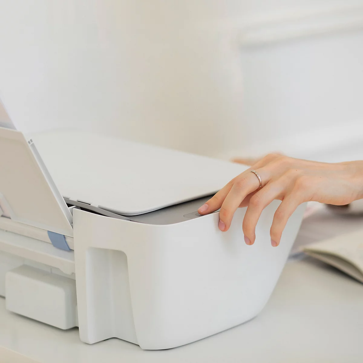 Hand bedient een witte printer, met tekst: Printercompatibiliteit voor inkjet- en laserprinters.