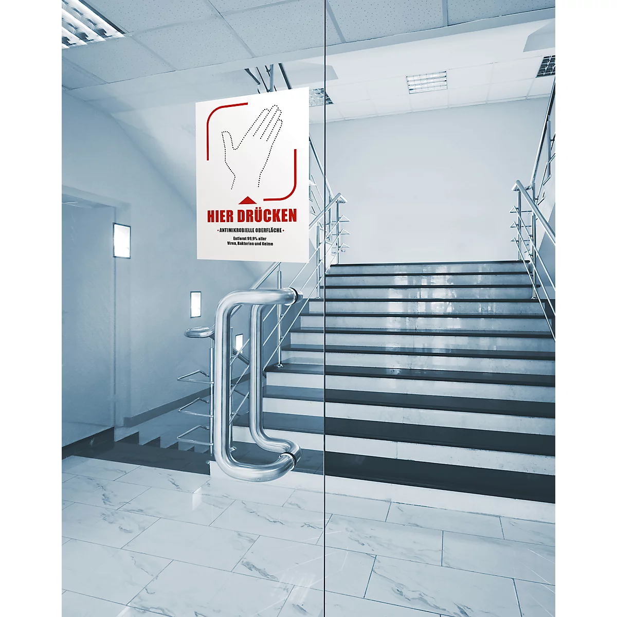 Porte en verre transparente avec un panneau indiquant "Appuyer ici". Un escalier en arrière-plan.