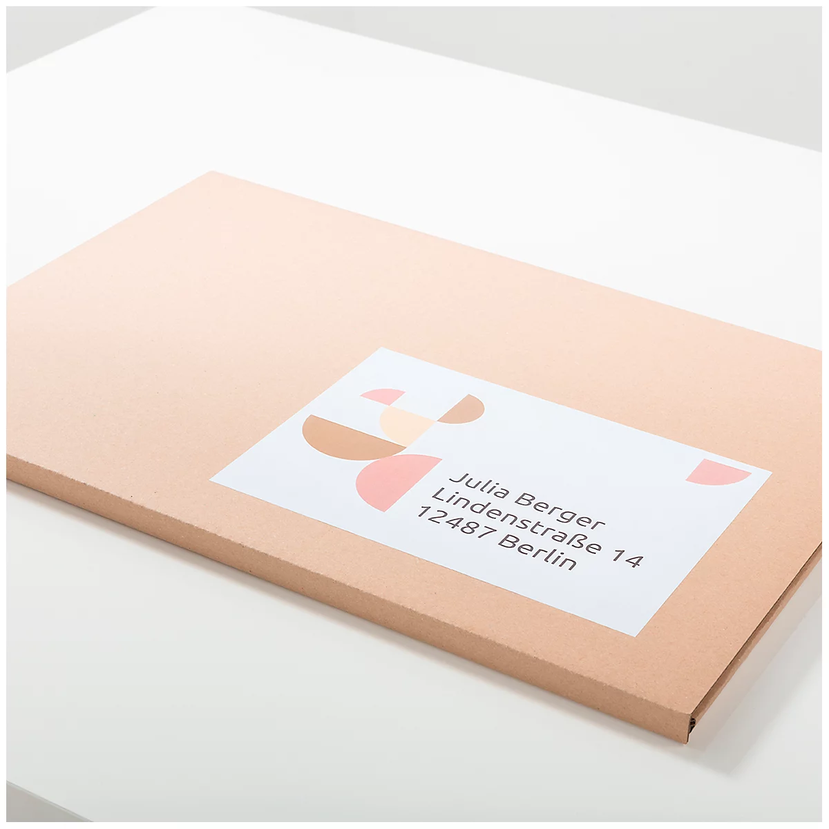 A beige envelope with a label. The label contains a name and address.