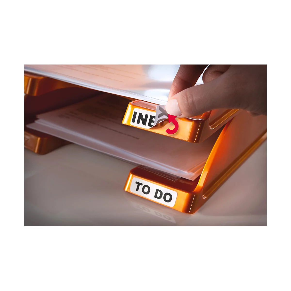 Person is sticking on an index sticker. The folder says "To Do".