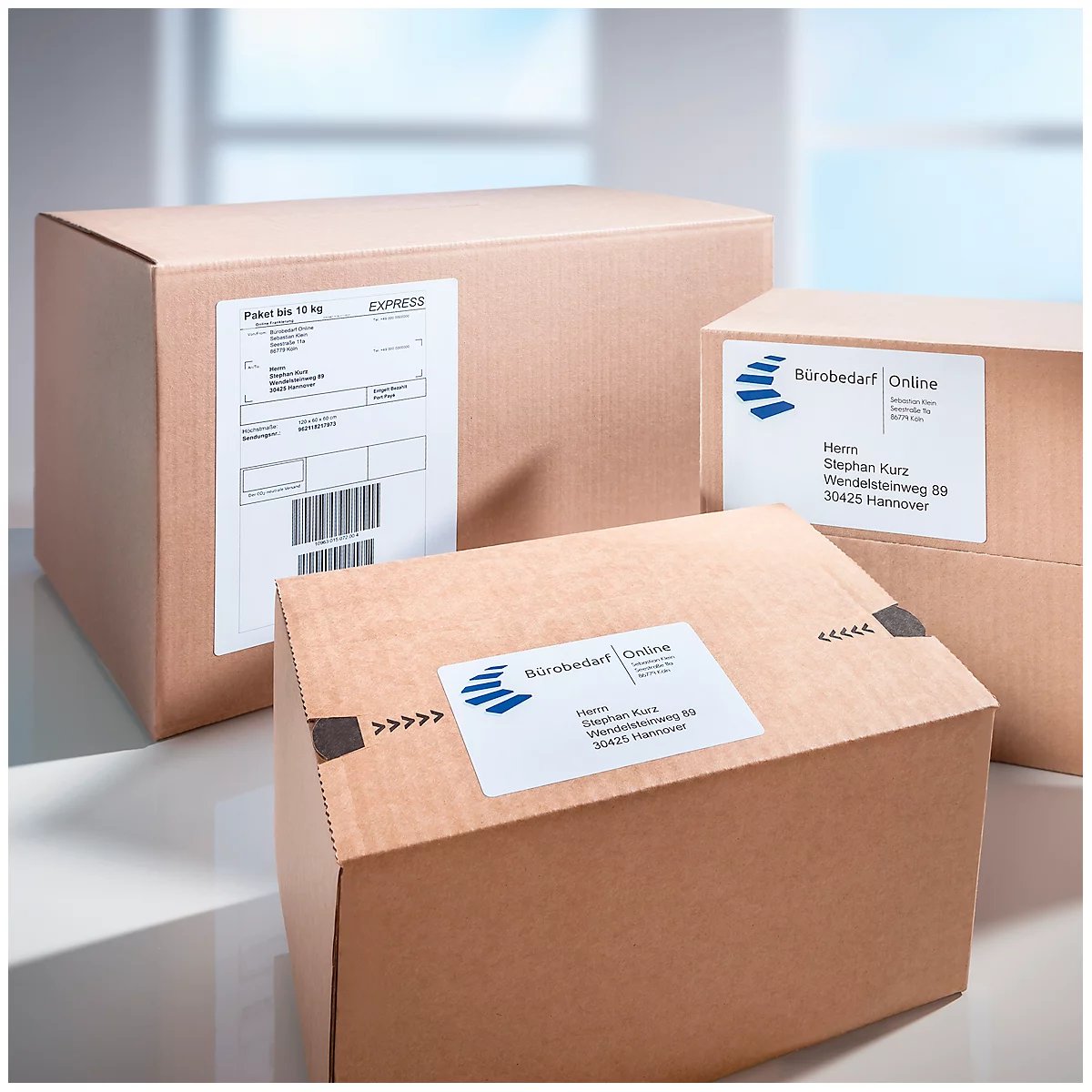 Three brown shipping boxes with shipping labels, labels with prints like "Office Supplies Online" and barcode.