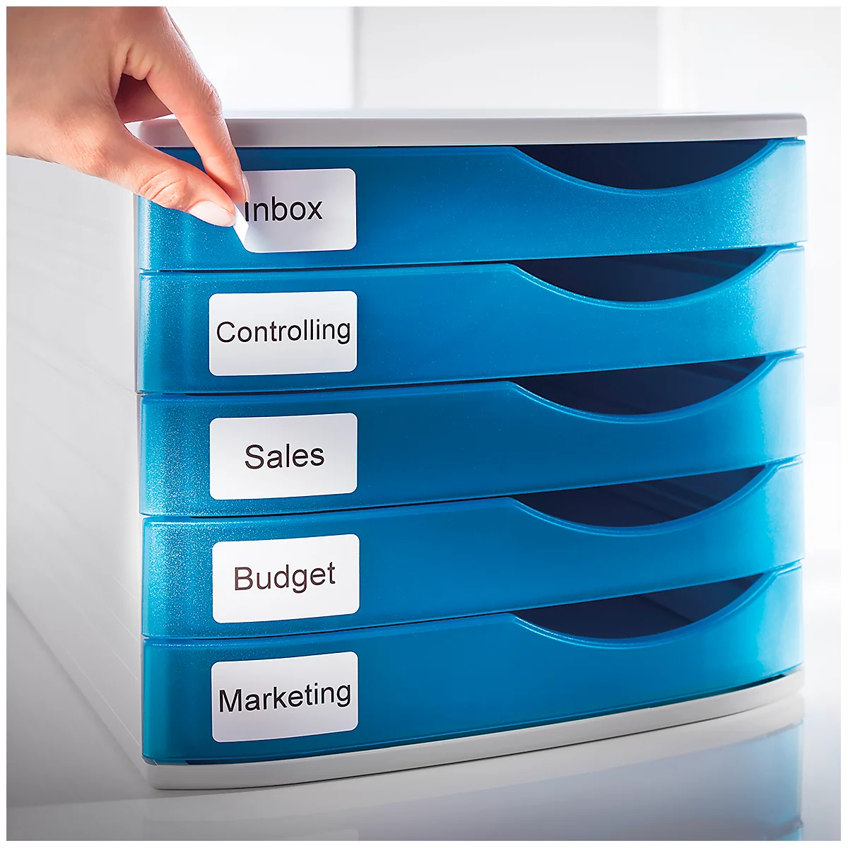 Hand adding an "Inbox" label to a blue drawer box. Other labels: Controlling, Sales, Budget, Marketing.