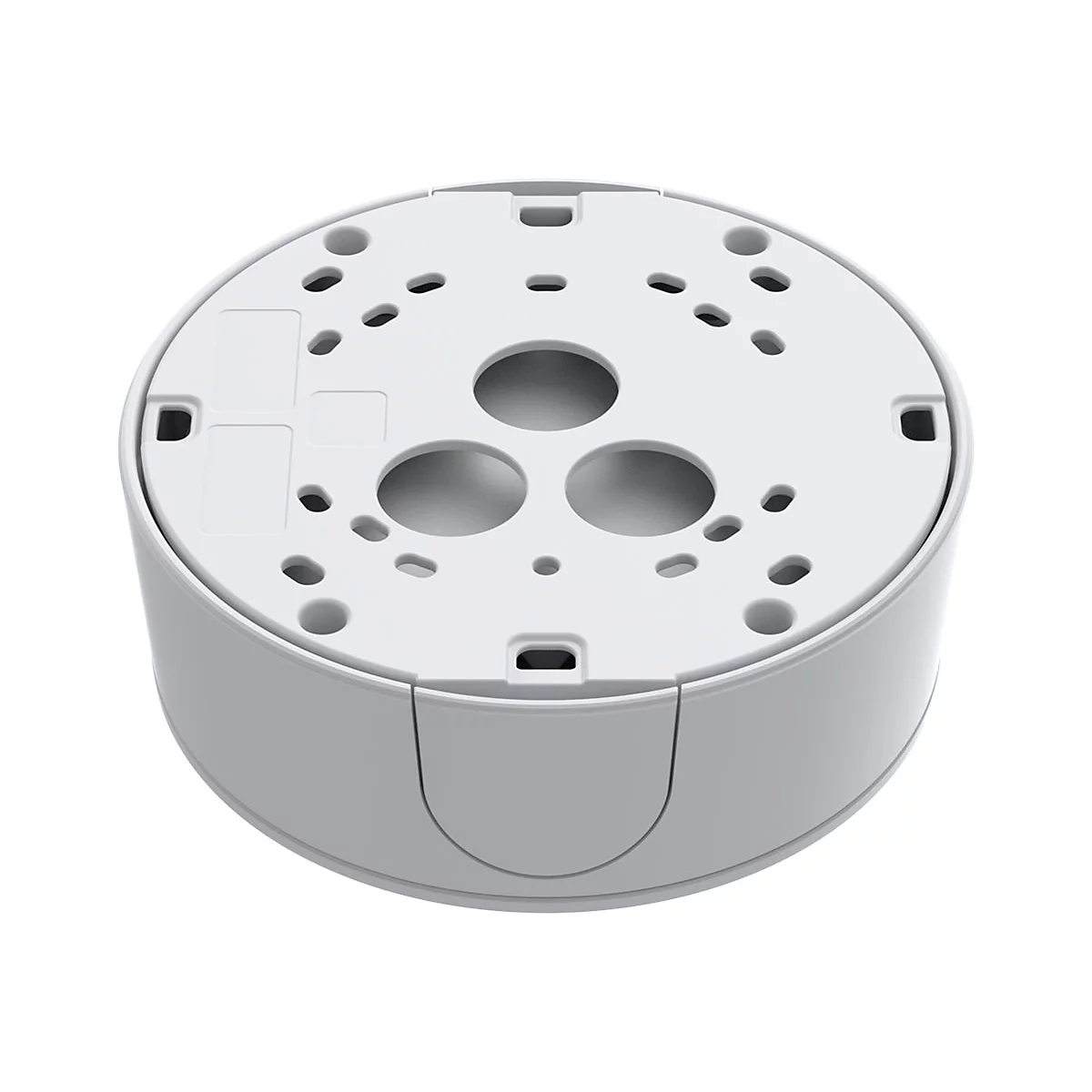 Appareil cylindrique gris clair, dessous avec trous et évidements ronds.