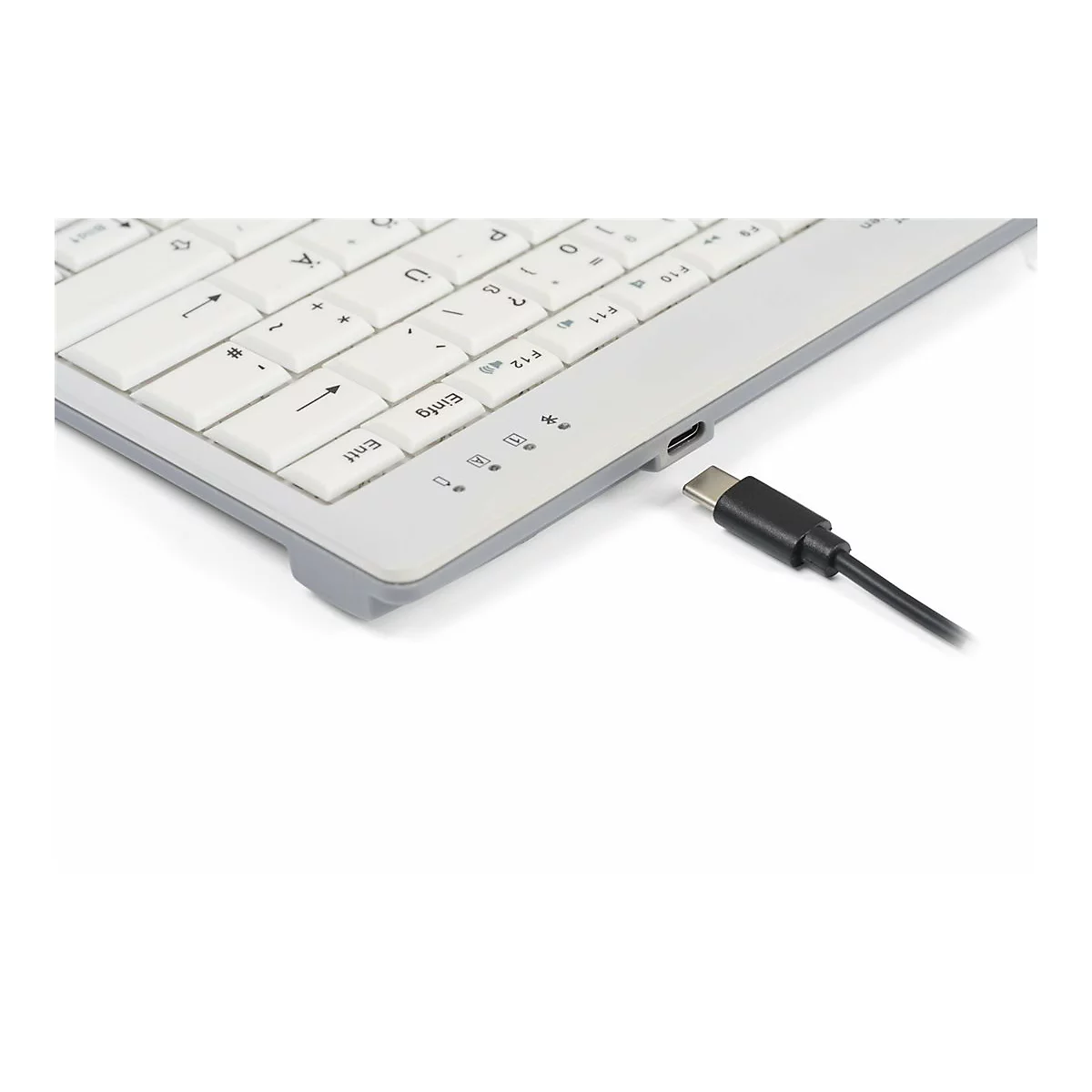 Nahaufnahme einer weißen Tastatur mit USB-C-Kabelanschluss an der rechten Seite vor weißem Hintergrund.