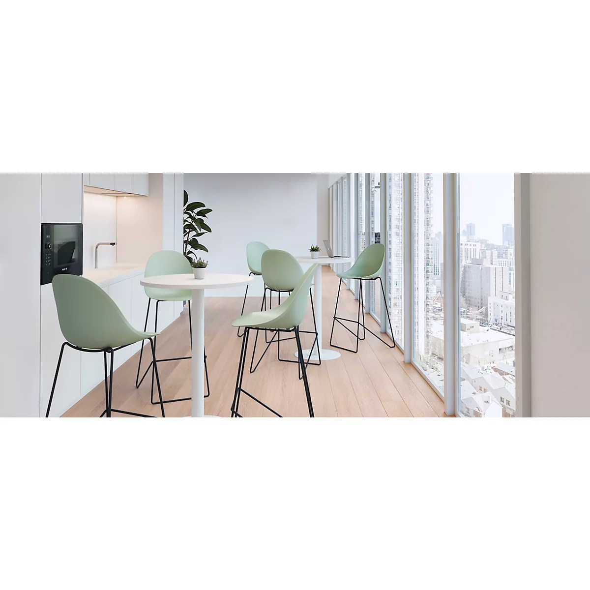 Bright room with wooden floor. Several green bar stools and tables stand in front of large windows with city views.