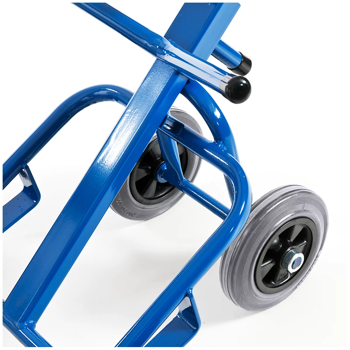 Close-up of a blue hand truck with gray tires and black rim.