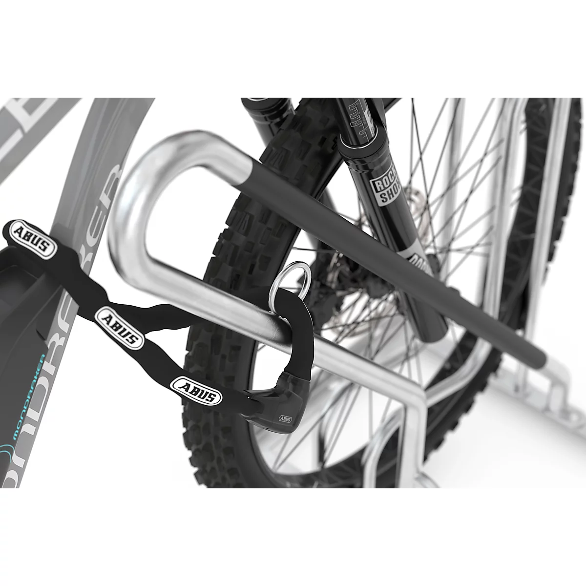Close-up of a bicycle lock with a chain, brand ABUS, attached to a bicycle.