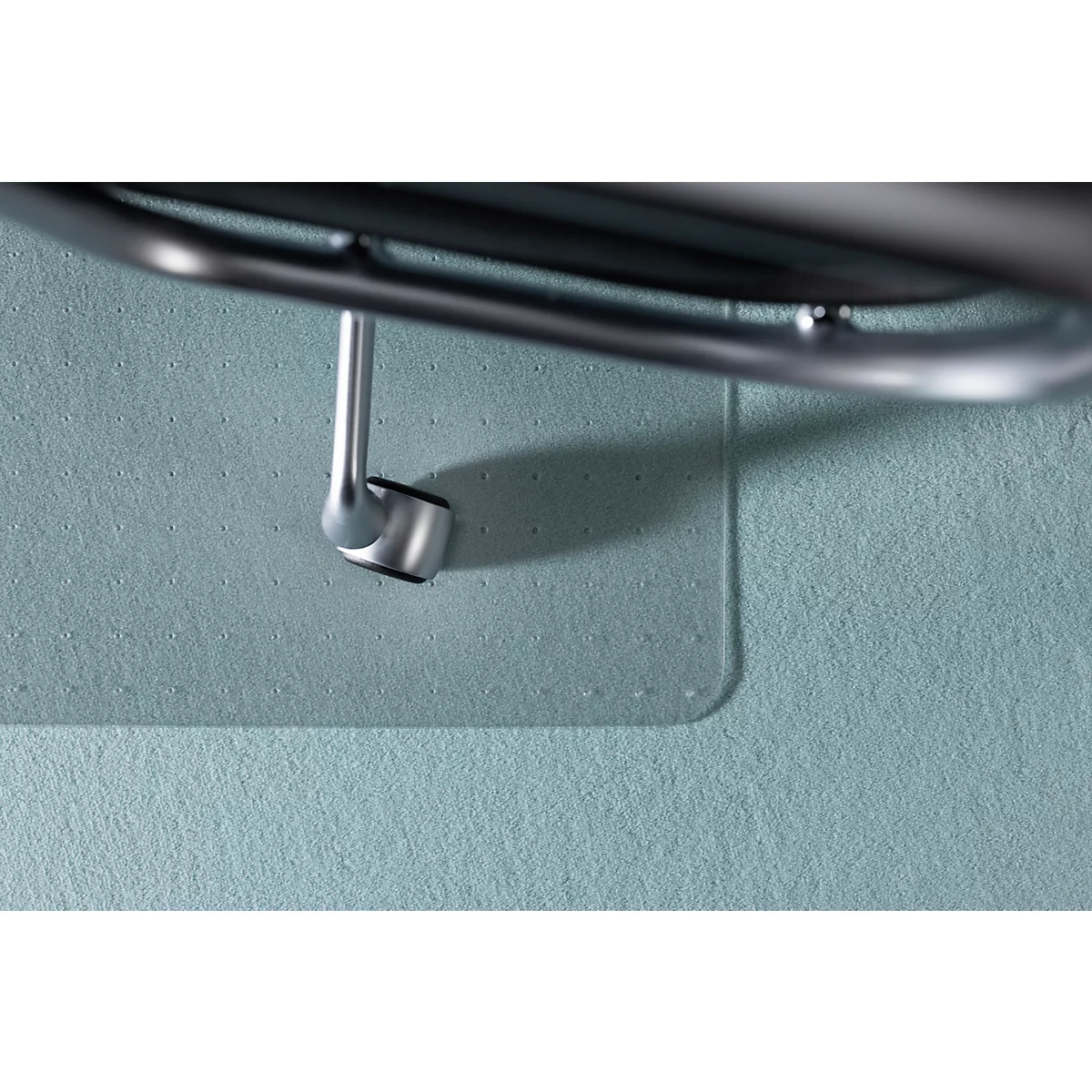 Detailaufnahme einer Halterung aus Metall vor hellblauem Hintergrund.