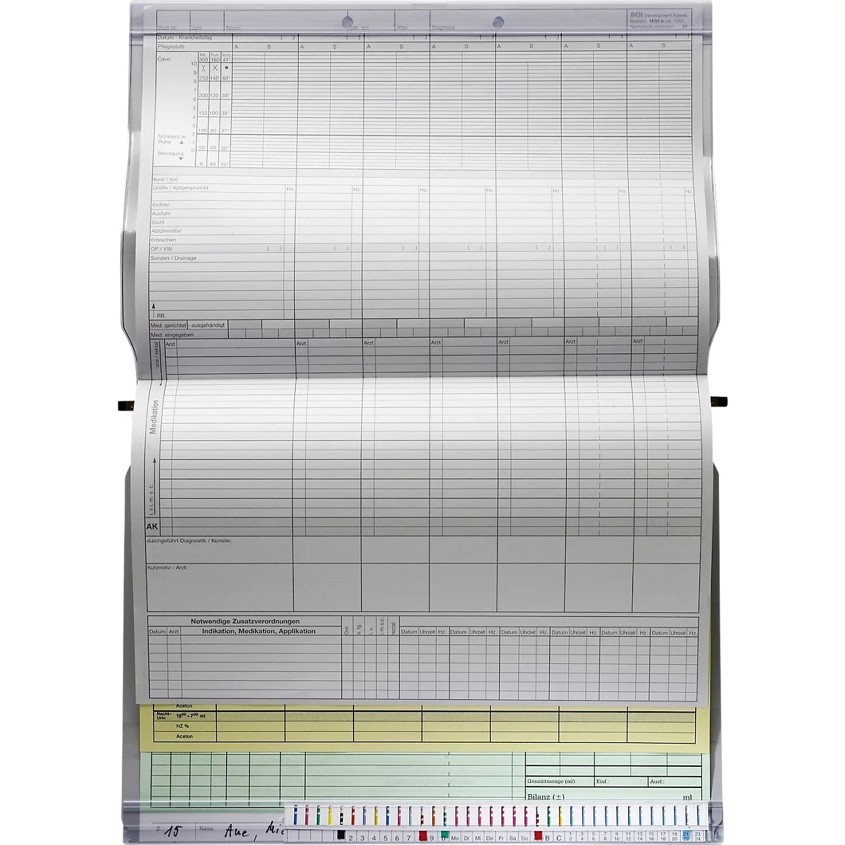 Open, gelijnd notitieboek. Gele, groene en gekleurde strepen aan de onderkant, met opschrift.