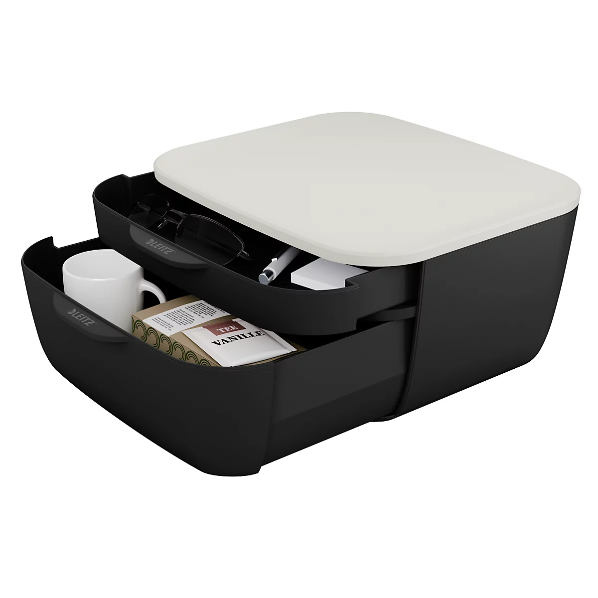 Boîte à tiroirs noire avec couvercle crème, remplie de lunettes, d'un stylo, d'une tasse et d'un emballage de vanille.