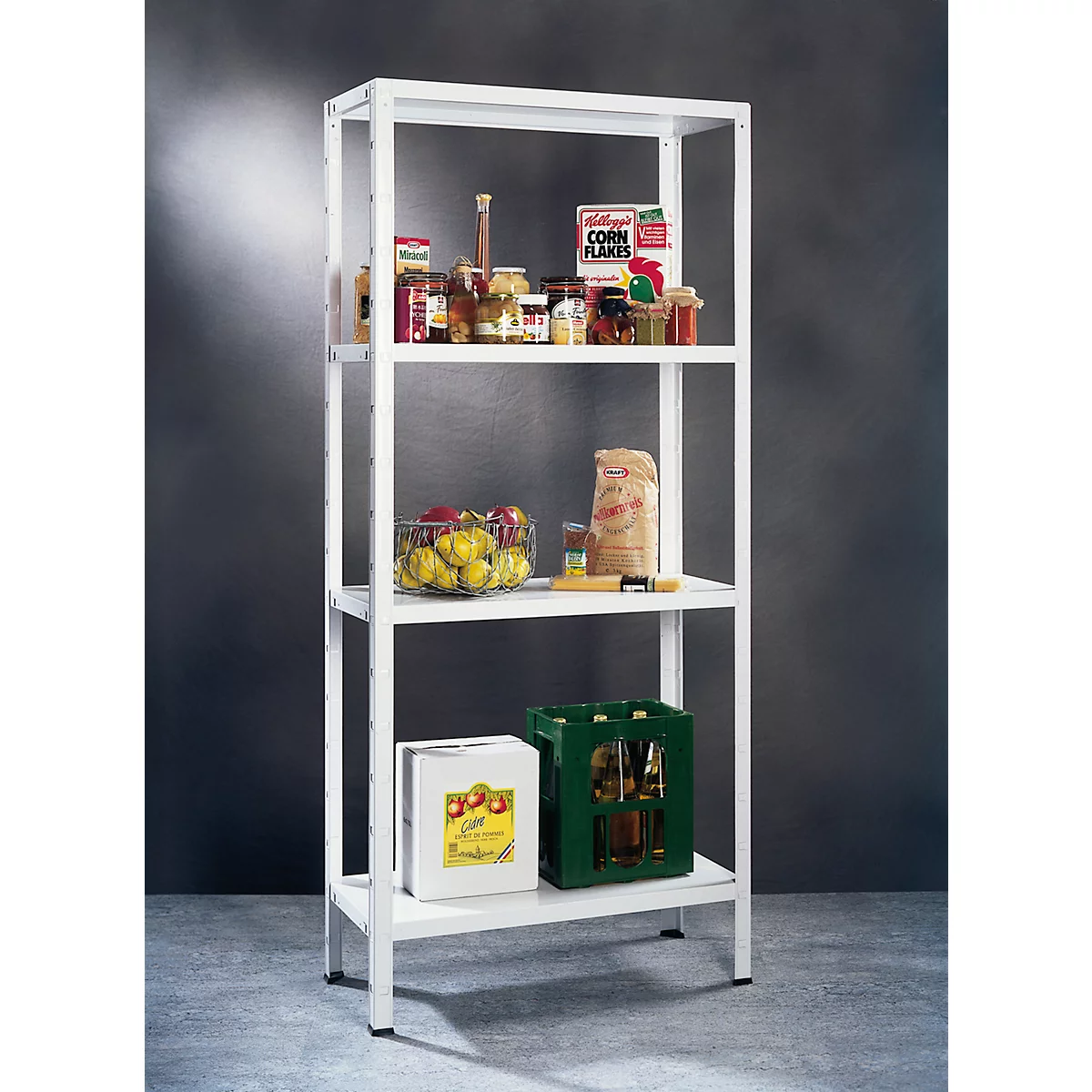 White four-tier shelf filled with groceries. Including a crate of beer and a crate of juice.
