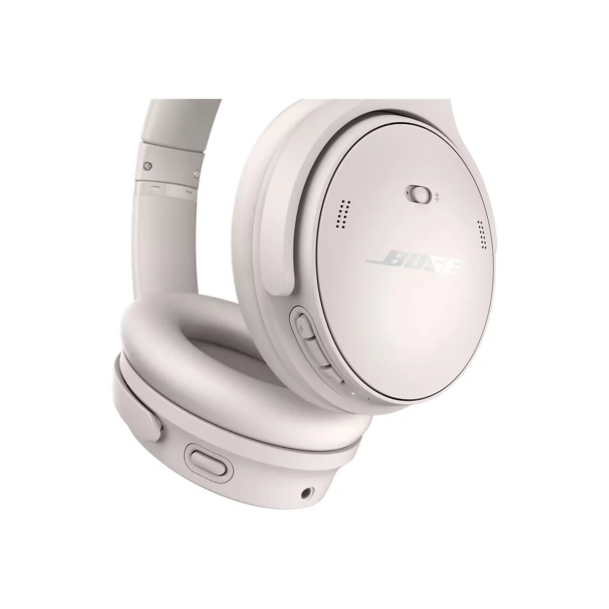 Nahaufnahme der rechten Ohrmuschel eines beigen Bose Over-Ear-Kopfhörers mit sichtbaren Bedientasten.