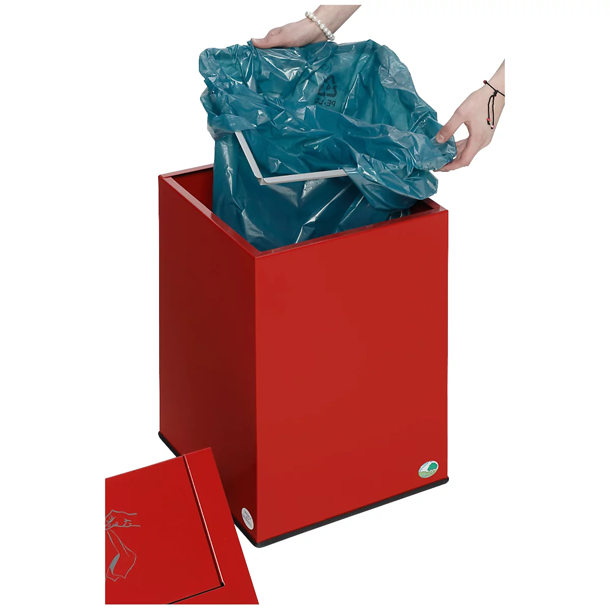 Red trash can with open lid. Hands holding a blue trash bag.