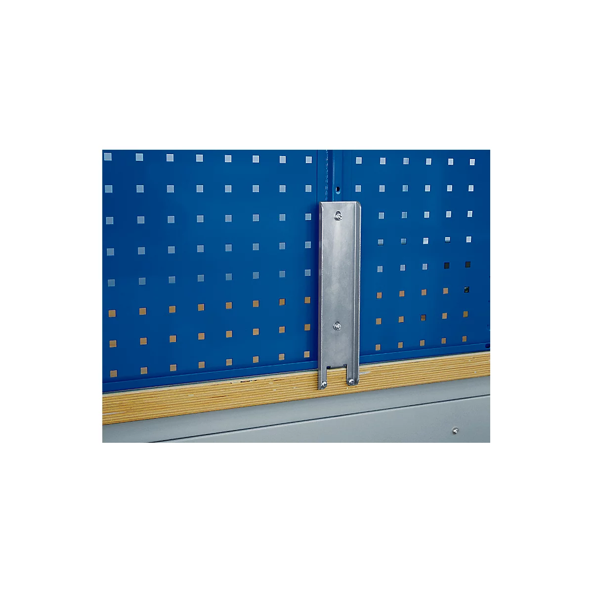 Metal bracket on blue tool wall. Wooden strip below, metal bracket above.