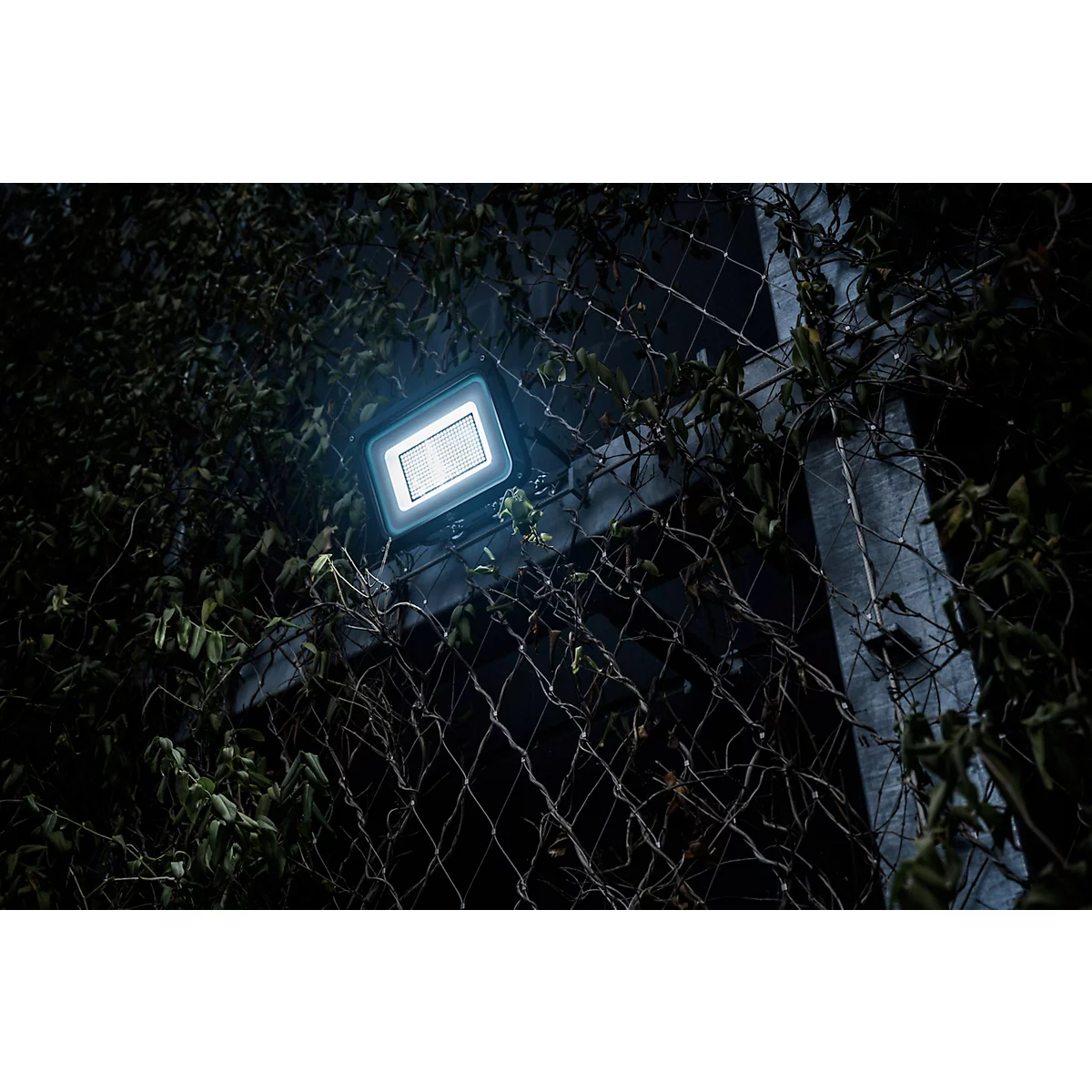 Detailaufnahme eines schwarzen Kabeleinführungsstutzens, der in eine dunkle Oberfläche eingeschraubt ist.