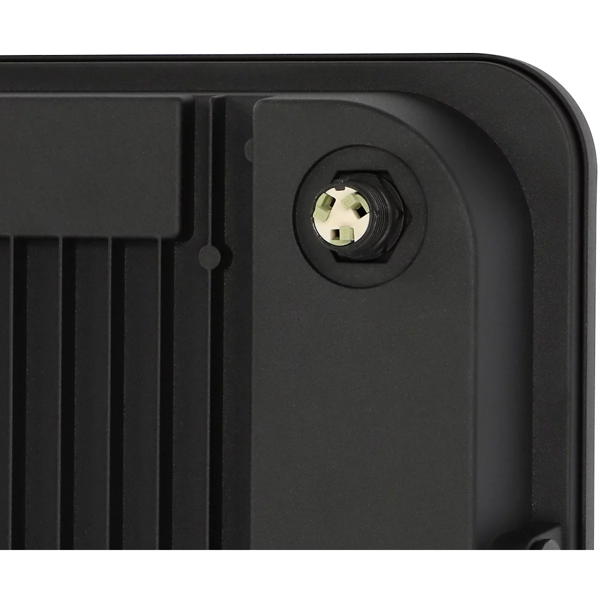 Composant électronique noir de profil, avec des vis et un bouton.