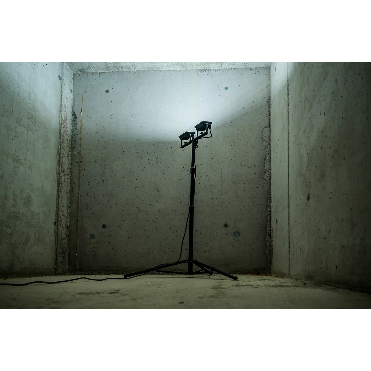 Nahaufnahme von schwarzem Stativbein mit Kabeln. Der Fuß ist auf einem Stativ befestigt.